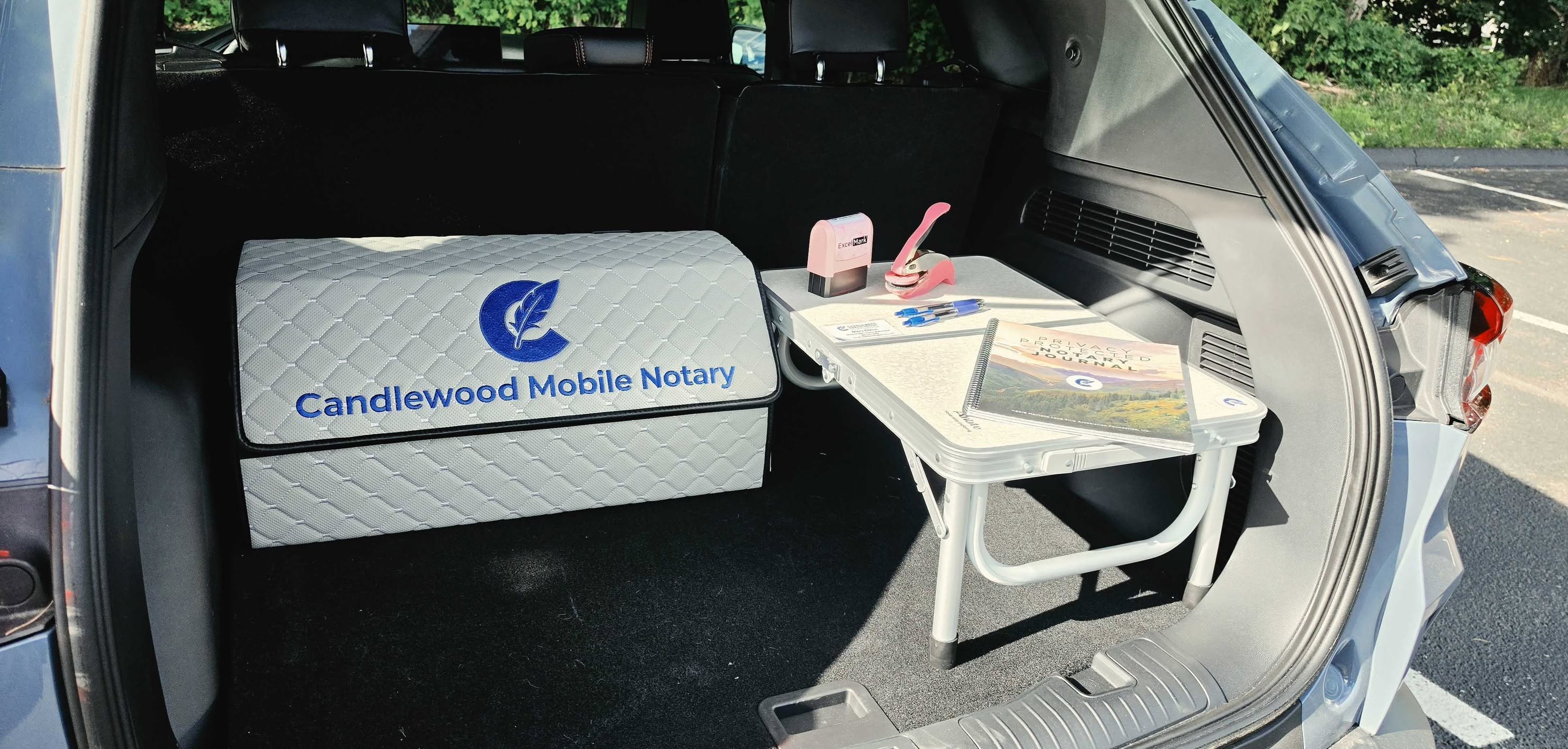 Candlewood Mobile Notary branded setup in vehicle trunk with notary tools and supplies